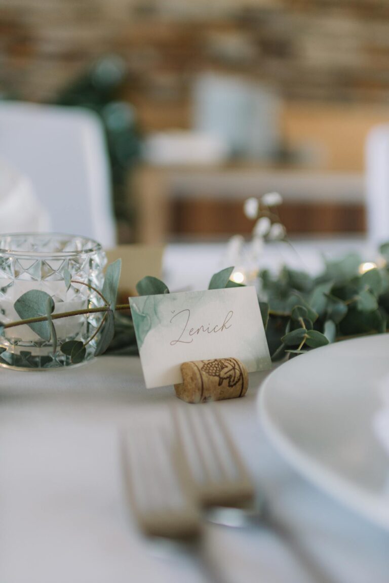 Beautifully arranged wedding table setting featuring a name card and delicate decor.