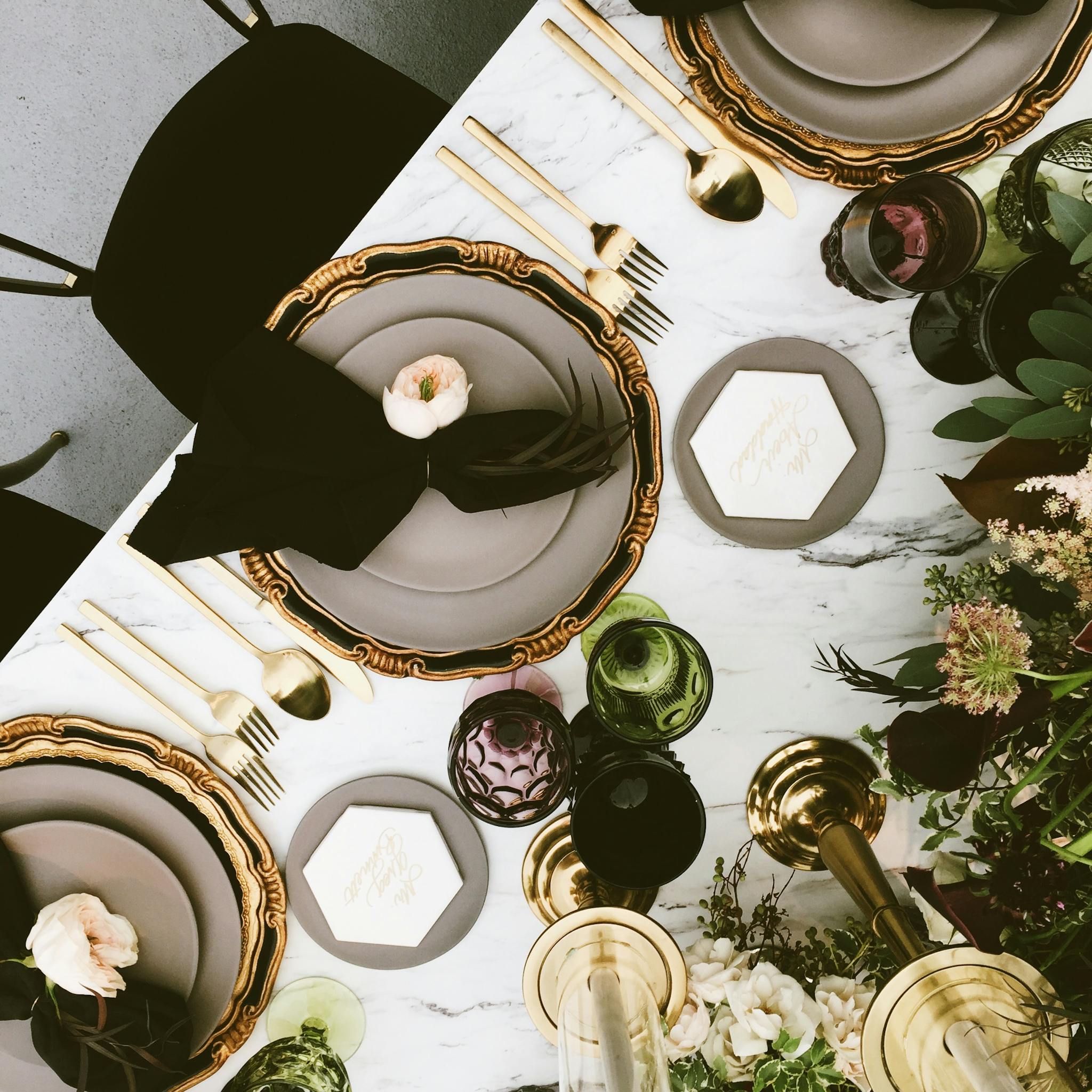 Chic table setting in Beverly Hills featuring gold accents and floral decor.